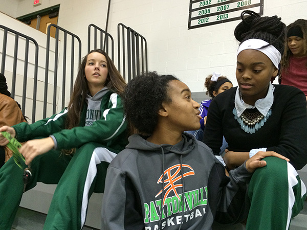 Photo: Pattonville High School basketball players (left to right) Cassie Callahan, Allyson Sanders, and Tyra Brown watch the B-squad before a home game in Maryland Heights, Missouri. Photo by John Biewen.